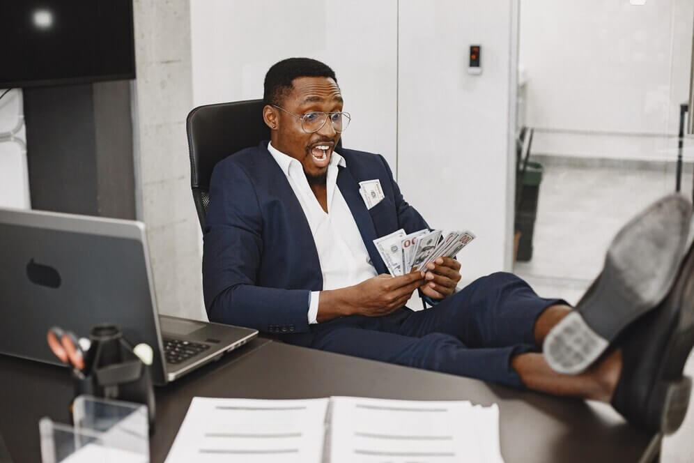 african-man-black-suit-guy-sitting-table-businessman-with-money